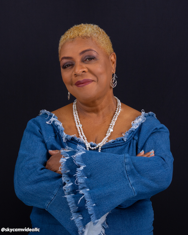 Professional studio portrait of a woman against a dark background